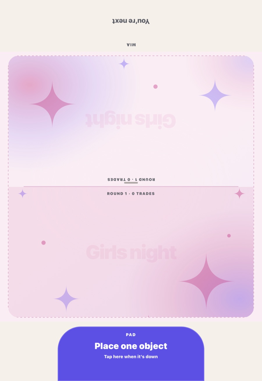 An iPad lying between two players, split into two halves with a Girls night theme